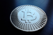 A mock bitcoin, decoration or toy, holds no actual bitcoin. Made of brass. - Copyright: Isokivi