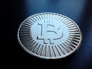 A mock bitcoin, decoration or toy, holds no actual bitcoin. Made of brass.